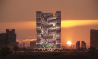 Tour Binghatti Hills avec ciel de coucher de soleil et terrasses illuminées