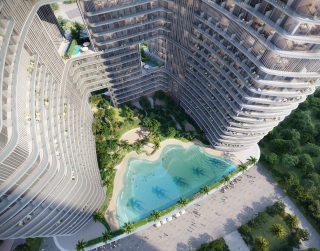 Vue aérienne de la tour Binghatti Hillviews avec piscine et jardins