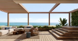 Terrasse sur le toit avec jacuzzi et sièges vue sur l'océan