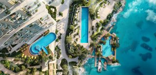 vue aérienne du front de mer de Sensia avec piscines, marina et océan